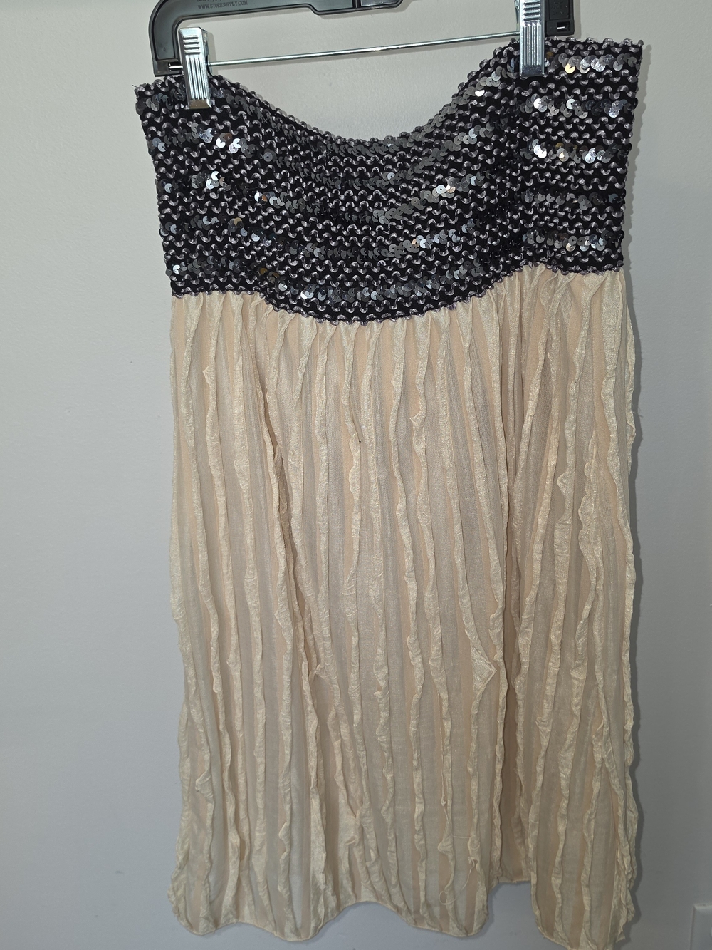 Black and beige sequin dress with silver sequins on the bodice and beige pleated